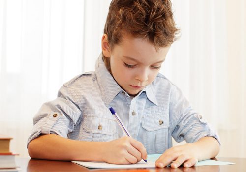 Young boy writing